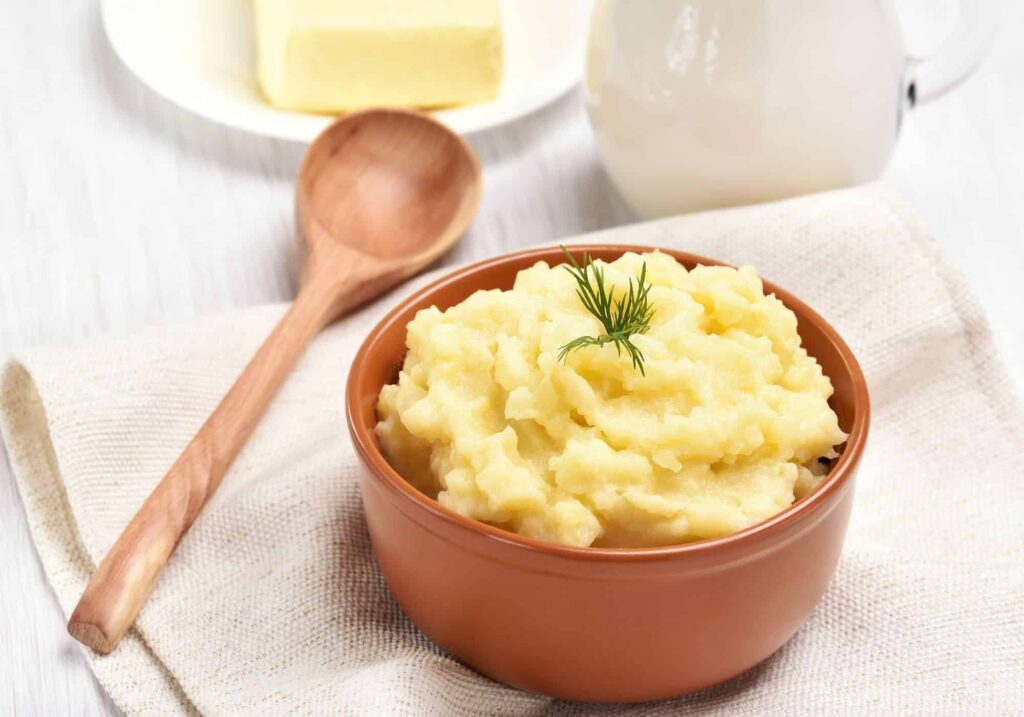 Dairy Free Mashed Potatoes in a ceramic bowl with a spoon